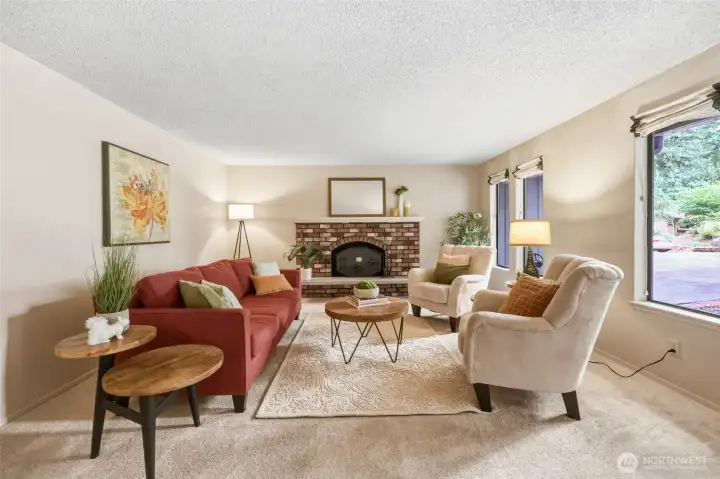 Welcome inside! Brand NEW bleached almond carpet brightens the entire main level and creates a fresh backdrop for every style of décor. The portrait-style windows continue that wonderful mid-century nod in this living room while filling the living room with beautiful natural light, softened by custom Roman shades. Anchoring the space is the original brick hearth and mantle with a custom-crafted wood stove that's as much a conversation piece as it is a cozy place to gather on cool Northwest evenings. Prefer an open fireplace view? The original fire screen is also included, giving you the flexibility to enjoy either look. Welcome inside! Brand NEW bleached almond carpet brightens the entire main level and creates a fresh backdrop for every style of décor. The portrait-style windows continue that wonderful mid-century nod in this living room while filling the living room with beautiful natural light, softened by custom Roman shades. Anchoring the space is the original brick hearth and mantle with a custom-crafted wood stove that's as much a conversation piece as it is a cozy place to gather on cool Northwest evenings. Prefer an open fireplace view? The original fire screen is also included, giving you the flexibility to enjoy either look.