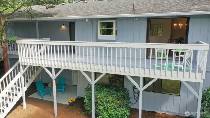 It's hard to appreciate just how impressive this outdoor living space is until you see it from above. Stretching nearly the full length of the home, this expansive deck creates multiple areas for dining, relaxing and entertaining, all connected to the main living spaces through both the dining room French doors and the kitchen slider. Notice the garden window tucked just outside the kitchen sink, along with the stairs leading directly to the backyard below. This aerial also gives you a great look at the daylight basement, where oversized windows and a patio just outside the family room make the lower level feel bright, welcoming and truly connected to the outdoors. It's hard to appreciate just how impressive this outdoor living space is until you see it from above. Stretching nearly the full length of the home, this expansive deck creates multiple areas for dining, relaxing and entertaining, all connected to the main living spaces through both the dining room French doors and the kitchen slider. Notice the garden window tucked just outside the kitchen sink, along with the stairs leading directly to the backyard below. This aerial also gives you a great look at the daylight basement, where oversized windows and a patio just outside the family room make the lower level feel bright, welcoming and truly connected to the outdoors.