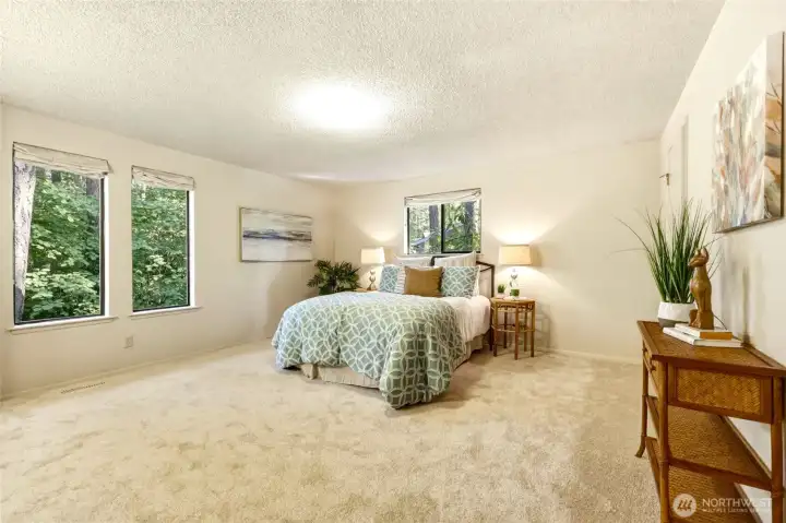 Located on the main floor, this spacious primary suite offers a peaceful place to begin and end each day. Brand NEW bleached almond carpet, custom Roman shades and large windows filled with beautiful greenery create a room that feels wonderfully private without sacrificing natural light. One of my favorite things is that your view isn't another bedroom window...it's mature Pacific Northwest landscaping that has been quietly growing in for decades. This is the kind of privacy that's hard to create overnight. Located on the main floor, this spacious primary suite offers a peaceful place to begin and end each day. Brand NEW bleached almond carpet, custom Roman shades and large windows filled with beautiful greenery create a room that feels wonderfully private without sacrificing natural light. One of my favorite things is that your view isn't another bedroom window...it's mature Pacific Northwest landscaping that has been quietly growing in for decades. This is the kind of privacy that's hard to create overnight.