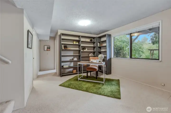 Welcome to the daylight basement, where you'll quickly discover this isn't "just a basement." Large picture windows fill the space with natural light while durable low-profile Berber carpet is ready for movie nights, game nights, kids, pets and everyday life without asking you to tiptoe around it. Built-in bookshelves create the perfect spot for a reading nook, home office or game table, while the hallway beyond leads to two additional BRs, a full bathroom and the laundry room. Mini blinds throughout the lower level provide easy light and privacy control, making every room feel comfortable and inviting. Welcome to the daylight basement, where you'll quickly discover this isn't "just a basement." Large picture windows fill the space with natural light while durable low-profile Berber carpet is ready for movie nights, game nights, kids, pets and everyday life without asking you to tiptoe around it. Built-in bookshelves create the perfect spot for a reading nook, home office or game table, while the hallway beyond leads to two additional BRs, a full bathroom and the laundry room. Mini blinds throughout the lower level provide easy light and privacy control, making every room feel comfortable and inviting.