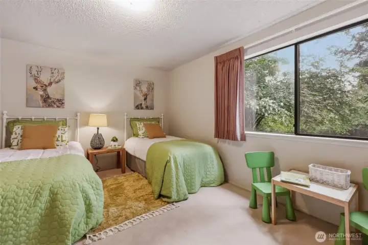 One of two lower-level bedrooms, this comfortable space enjoys peaceful backyard views and plenty of room to make it your own. Whether it's a guest room, a teenager's retreat, a hobby room or a dedicated home office, the generous layout easily adapts to your needs. The large closet provides excellent storage, while the recently professionally cleaned carpet and mini blinds mean it's ready for everyday living from day one. Once again, you'll notice how every window in this home seems to frame nothing but beautiful greenery. One of two lower-level bedrooms, this comfortable space enjoys peaceful backyard views and plenty of room to make it your own. Whether it's a guest room, a teenager's retreat, a hobby room or a dedicated home office, the generous layout easily adapts to your needs. The large closet provides excellent storage, while the recently professionally cleaned carpet and mini blinds mean it's ready for everyday living from day one. Once again, you'll notice how every window in this home seems to frame nothing but beautiful greenery.