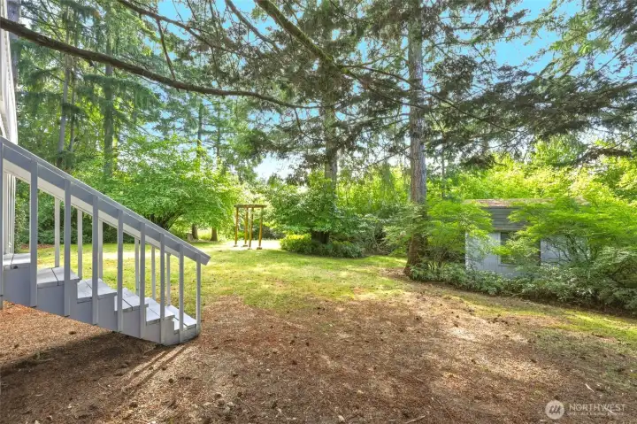 This view perfectly captures why this home has been so loved for over 50 years. Comfortable main floor living, an expansive deck, a wonderfully usable backyard and an extraordinary connection to nature all come together in one special setting. The arbor invites you toward another sunny gathering space, the shed is ready for your next project, and mature Pacific Northwest landscaping creates a beautiful sense of privacy in every direction. Homes come on the market every day. A setting like this is much harder to find. This view perfectly captures why this home has been so loved for over 50 years. Comfortable main floor living, an expansive deck, a wonderfully usable backyard and an extraordinary connection to nature all come together in one special setting. The arbor invites you toward another sunny gathering space, the shed is ready for your next project, and mature Pacific Northwest landscaping creates a beautiful sense of privacy in every direction. Homes come on the market every day. A setting like this is much harder to find.