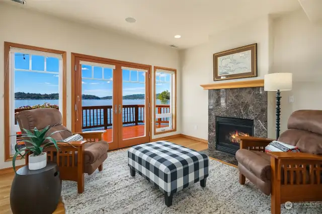Lower level sitting room with welcoming fireplace and French doors out to the lakefront deck.