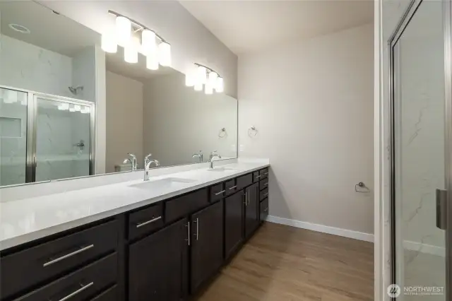The primary bath has double sinks and a lot of cabinets and counterspace.
