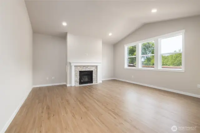 The great room has a gas fireplace, vaulted ceilings and lots of glass!