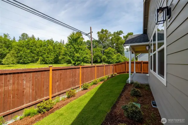 Fully fenced and landscaped backyard.