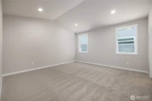 The primary bedroom has vaulted ceilings.