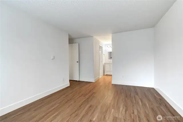 Another view of the primary bedroom leading to the vanity and walk in closet