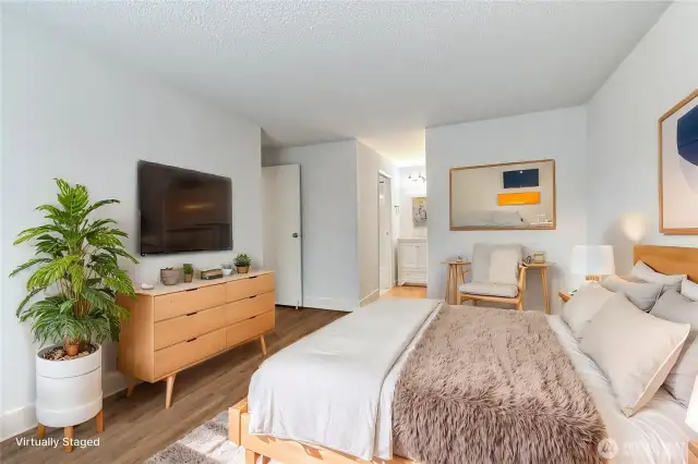 Another view of the primary bedroom leading to the vanity and walk in closet
