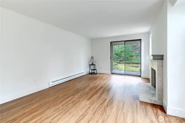 Step up to the living room with wood burning fireplace