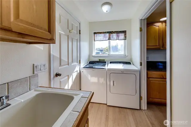 Laundry room is just off the kitchen and adjacent to the door to the garage. Home includes the washer and dryer.