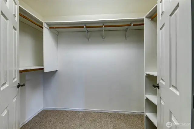 Well organized walk-in closet in the primary bedroom.