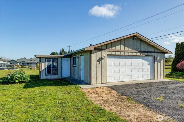 The detached garage offers many options with ample shelving for storage, lots of room for workbenches, and equipment.  There is even a woodstove and an attached room for gardening or hobbies.