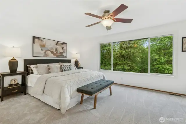 Large primary room with a ceiling fan.