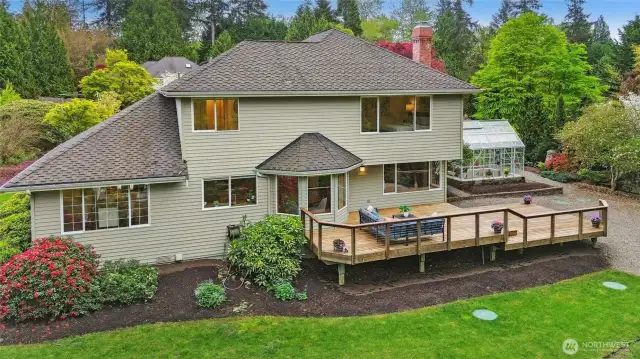 A stunning backyard setting is set amongst mature lush landscape, creating a private backyard oasis offering an entertainment sized deck and a delightful greenhouse.