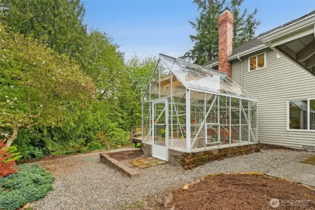 Fabulous greenhouse on the side yard.