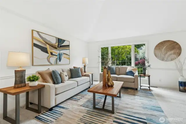 Formal living room with vaulted ceiling and stunning front yard views.