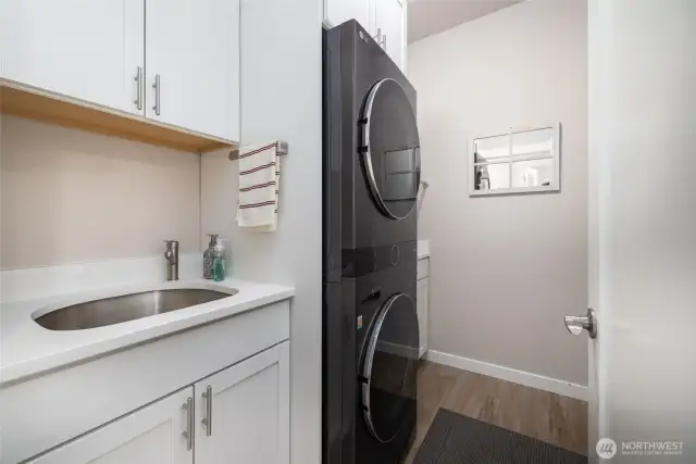 The utility was customized with matching cabinets, a utility sink and stackable steam washer/dryer that stays!