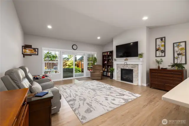 The great room has a gas fireplace, TV prep over fireplace and lots of glass/light from the slider and window wall.