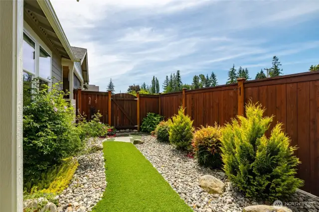 The seller put in pet turf and rocks for a beautiful yard low maintenance.