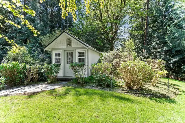 Large quaint shed in garden.
