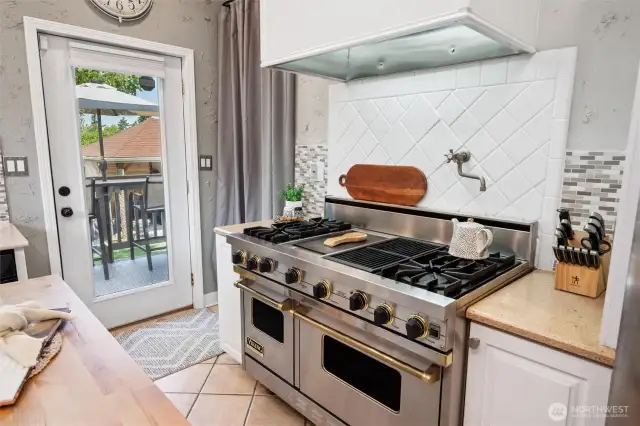 You'll love cooking on this Viking Range, with it's classic brass details, tiled backsplash and pot filler. Paired with your new dreamy backyard, your home will be top choice for hosting!