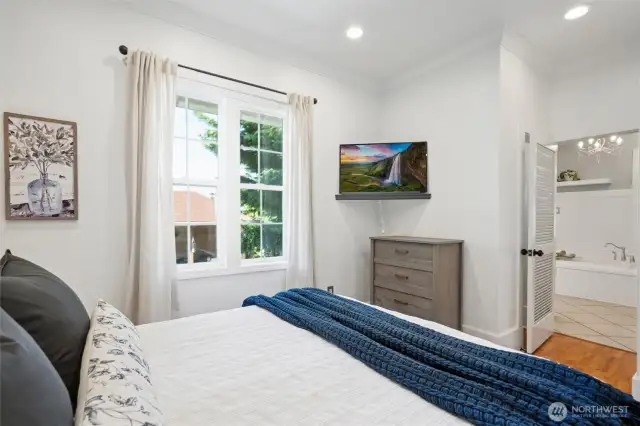 With a spacious ensuite bathroom and views into the backyard, the primary bedroom is the perfect blend of modern amenities and classic charm.