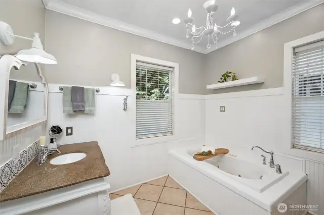 Featuring a soaking tub, tiled shower and tile floors, the primary bathroom is truly a place of zen.