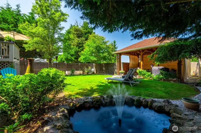 Or for a night in, enjoy the serenity of your peaceful backyard, surrounded by lush greenery, and the quiet calm of the water fountain.
