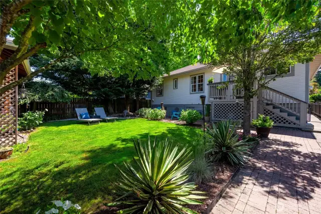 Fully fenced in, the yard is a canvas of curated landscaping, creating the perfect escape after a long day.
