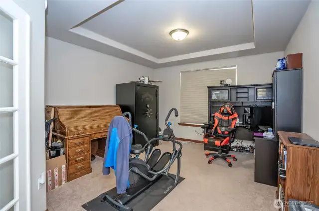 French doors open to a main floor den or home office, offering a quiet and flexible space.