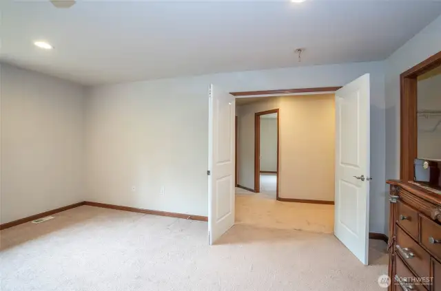 Step through grand double doors into the luxurious comfort of the primary suite.