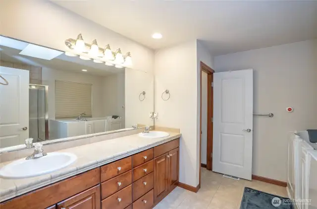 The primary en-suite is enhanced with dual sinks and an expansive countertop for added convenience and style.