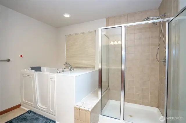 Enjoy the luxury of a walk-in tub and the practicality of a separate walk-in shower in the thoughtfully designed primary en-suite.