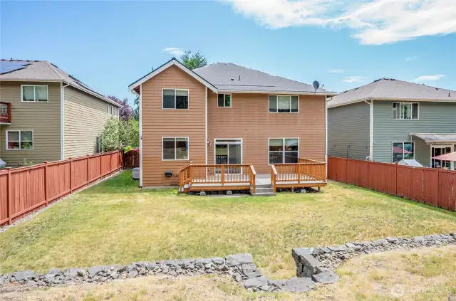 View from the upper-level backyard—so much space to relax or play, whether you're lounging on the new 2023 deck or enjoying the open yard below.