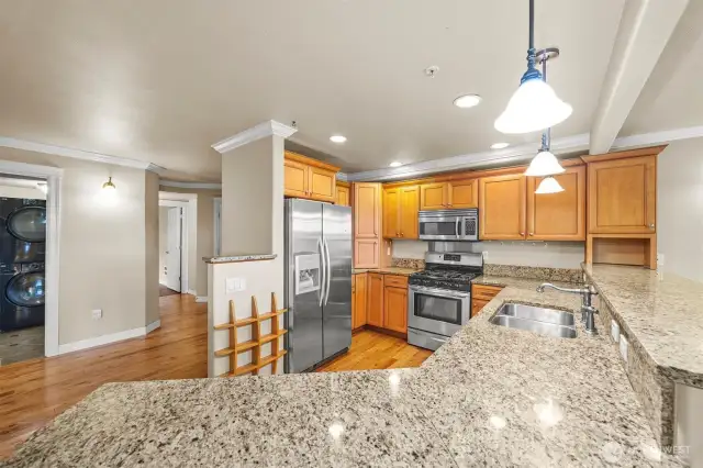 Kitchen has plenty of cabinet and counter space.  Door furthest on left leads to third bedroom.  Door closest is to utility room.