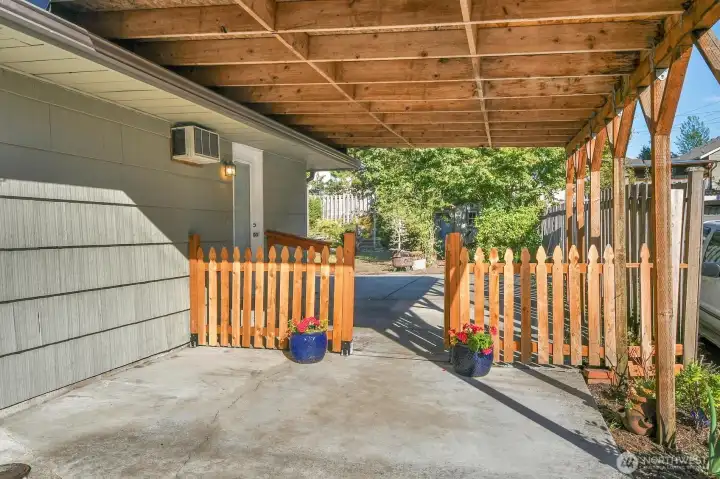 Carport with gate to backyard.