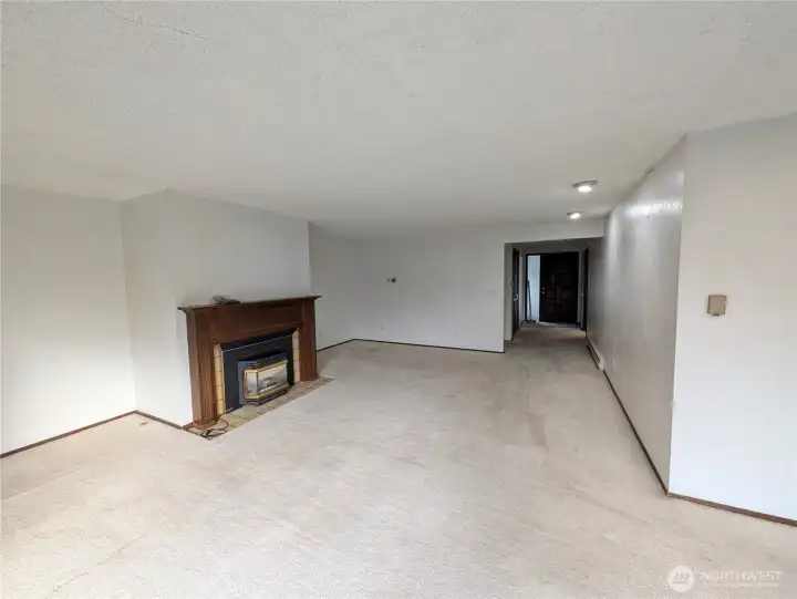 Large living rm with wood fireplace. Welcome to #11214 34th Ave E, Tacoma WA 98446. 3200+sf, 4+ br, 3 ba, 1.1 fenced acres.