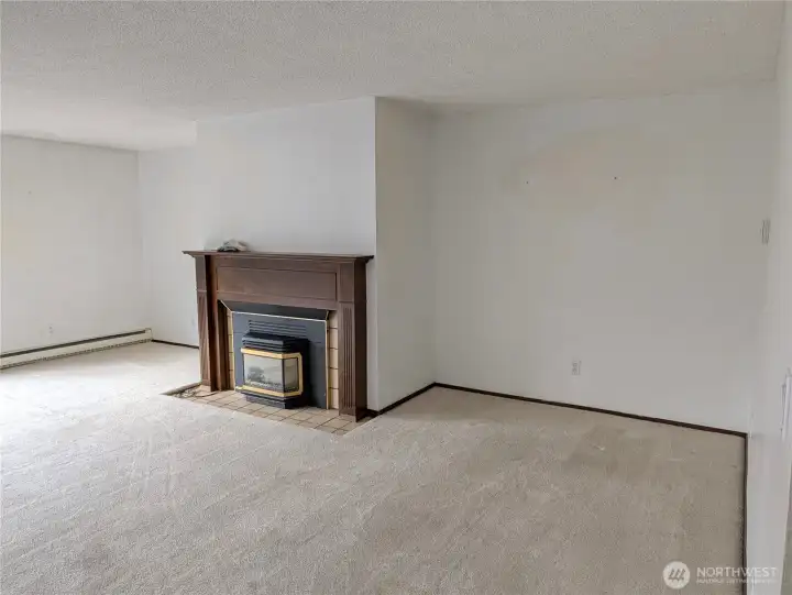 Large living rm with wood fireplace. Welcome to #11214 34th Ave E, Tacoma WA 98446. 3200+sf, 4+ br, 3 ba, 1.1 fenced acres.