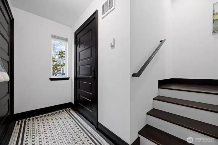 The spacious entryway offers space for hanging coats & bags plus there is a sweet built in shelf perfect for key storage etc. The door on the left opens to the garage