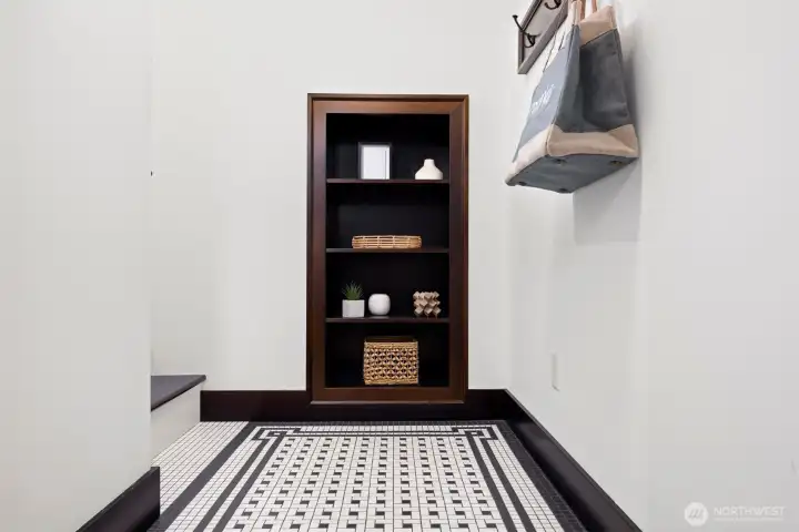 Notice the easy to maintain & beautiful tile floor plus the space saving built in shelving