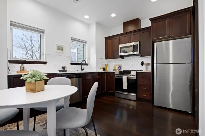 The kitchen offers abundant storage & counter space and is equipped with an induction range