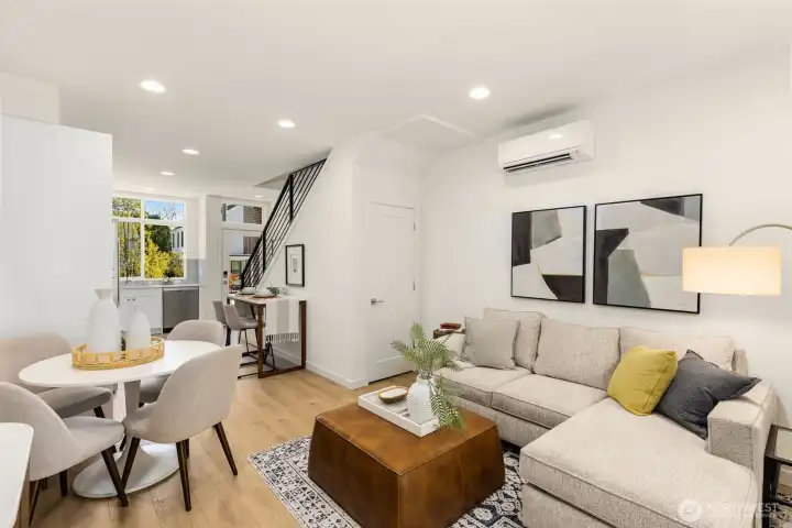 The open main level effortlessly flows between living, dining, and kitchen spaces for a natural sense of movement and ease.