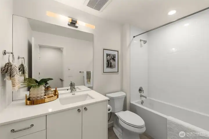 Sophisticated full bath with clean modern finishes and soft ambient lighting for a spa-like feel.