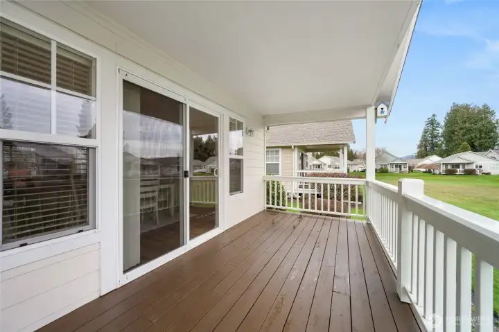 Covered back deck overlooks the green space.