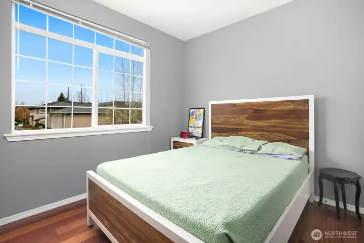 A well-positioned second bedroom and full bath provide flexibility for guests, a home office, or both.