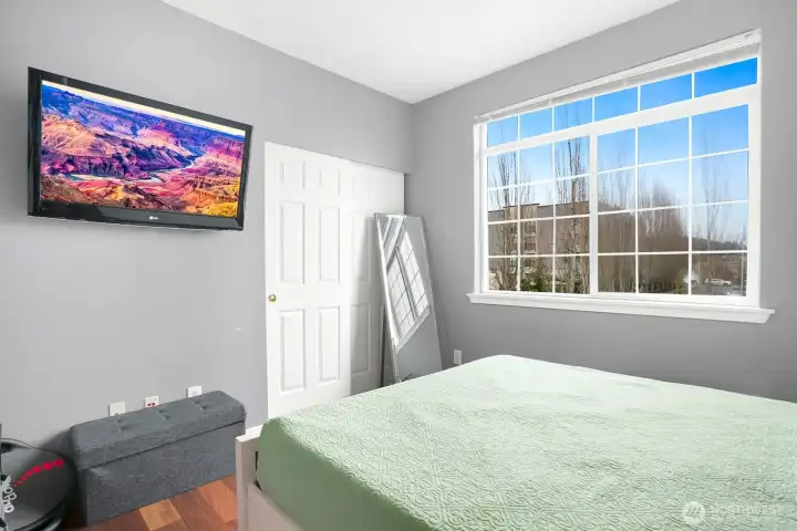 A well-positioned second bedroom and full bath provide flexibility for guests, a home office, or both.