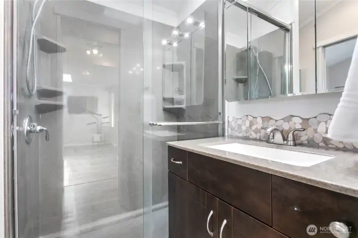 3/4 bathroom with large walk-in solid surface shower