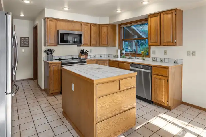 Kitchen and hallway leads to the mud/laundry room with an exterior door.