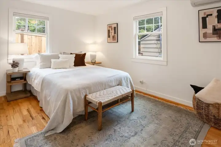 The first of two main floor bedrooms features hardwoods, a swanky closet system, Mini-split and natural light galore.
